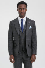 Man wearing a gray checkered suit with a blue tie and pocket square on a white background